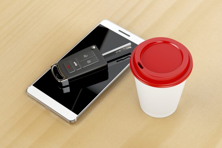 Smartphone, car key and coffee